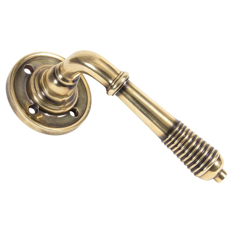 From The Anvil Reeded Beehive Door Handle on Rose – Aged Brass